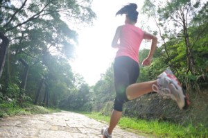 Runner athlete running on forest trail