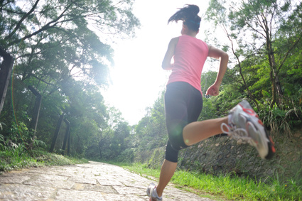 Runner athlete running on forest trail